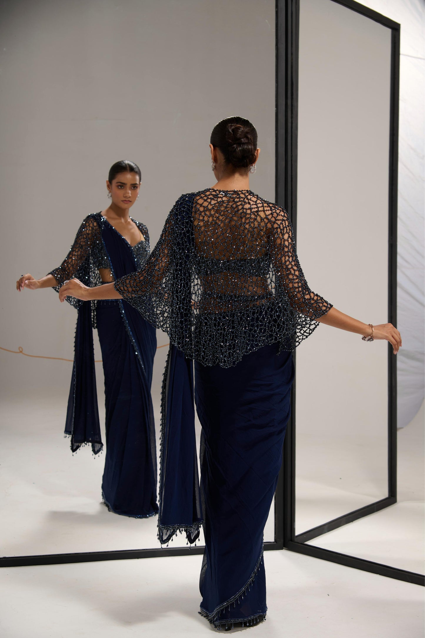 Navy blue saree set with
crystal cape